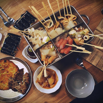 a wooden table topped with plates of food