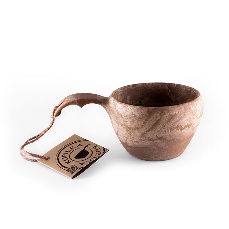 a coffee cup with a pair of scissors in it