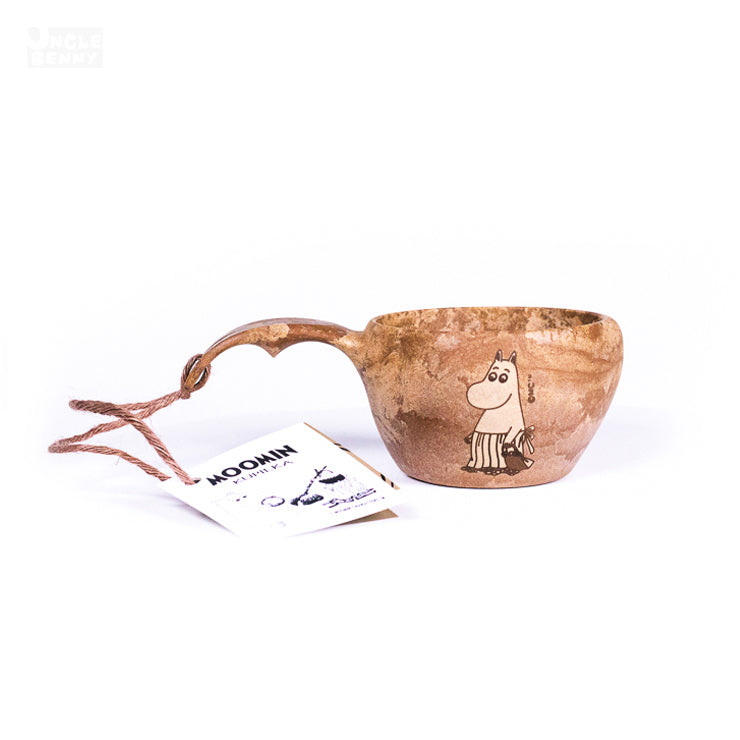 a teddy bear sitting in front of a book