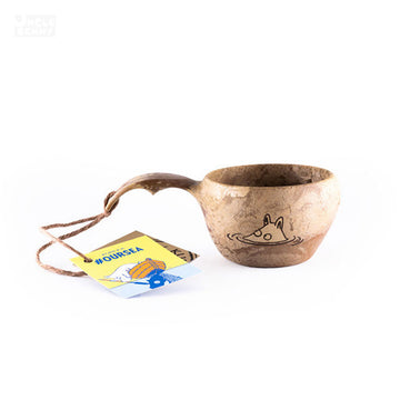 a coffee mug sitting on a table next to a cup