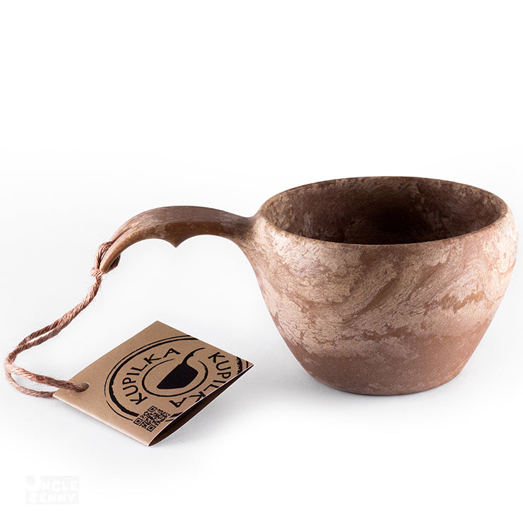 a coffee cup with a pair of scissors in it