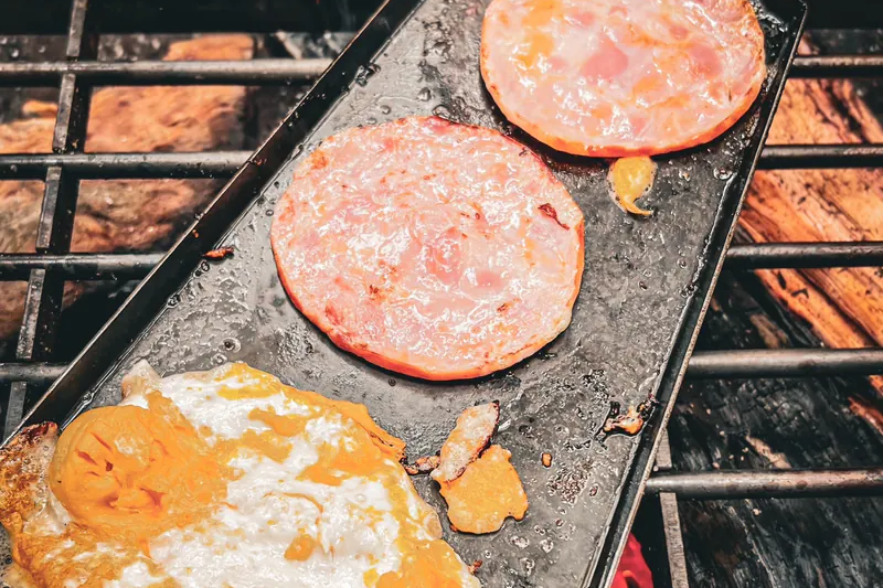 清空食材後的 Bush Griddle 鐵板表面,示意清潔前先移除大塊殘渣