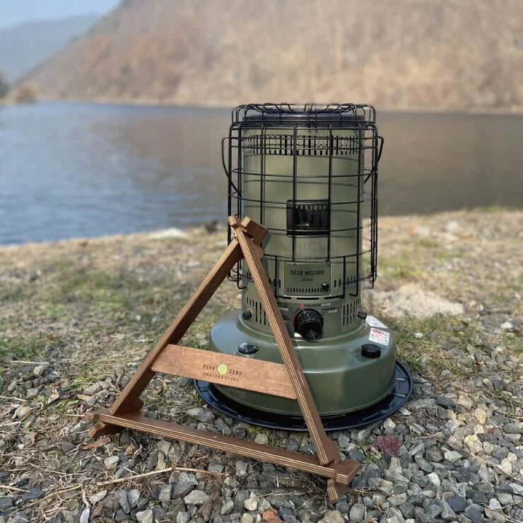 a bird cage sitting on top of a wooden bench 