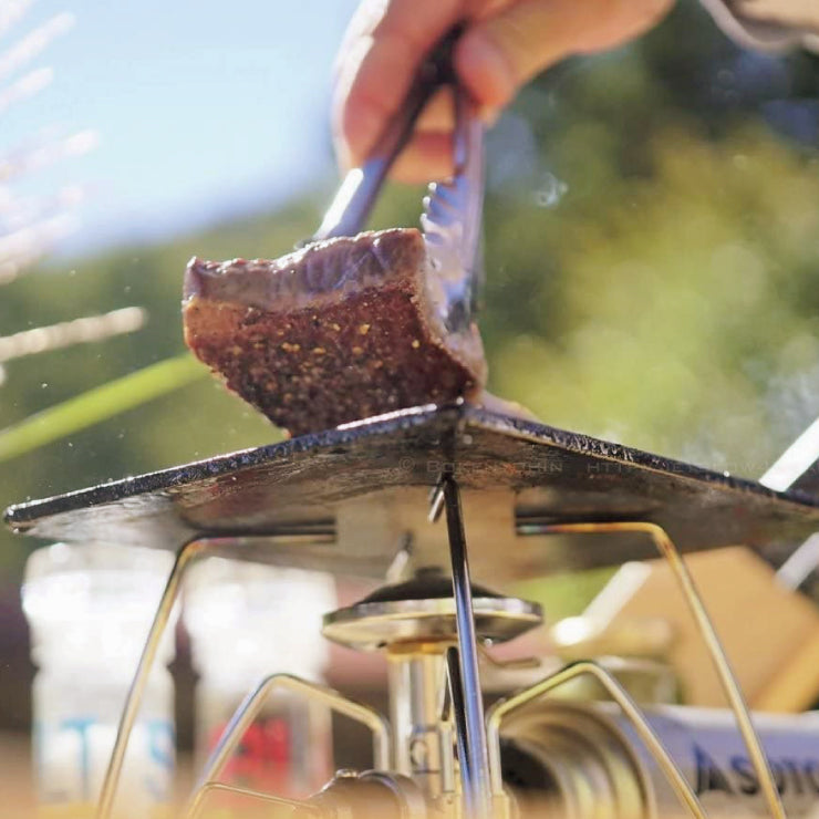 a person cutting a piece of chocolate cake 