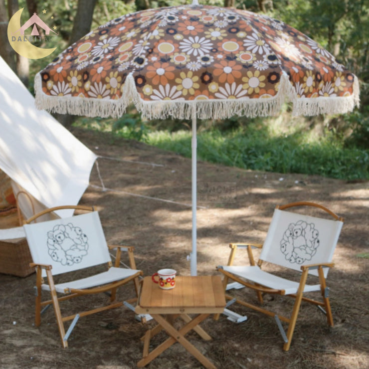 a couple of lawn chairs sitting under a umbrella 