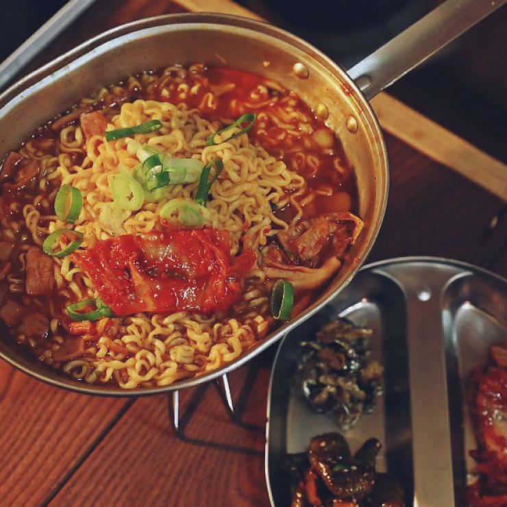 a pizza on a pan on a stove 