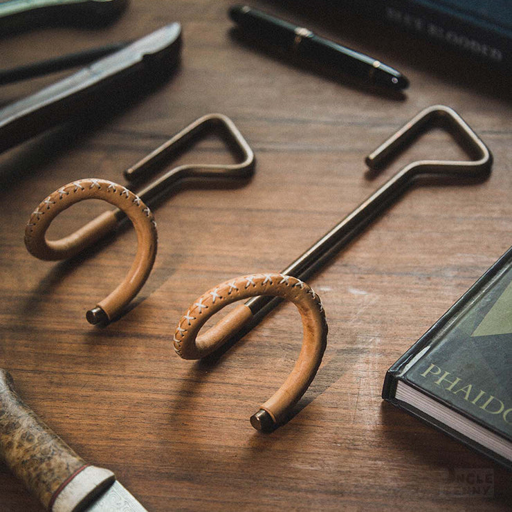 a pair of scissors sitting on top of a wooden table 