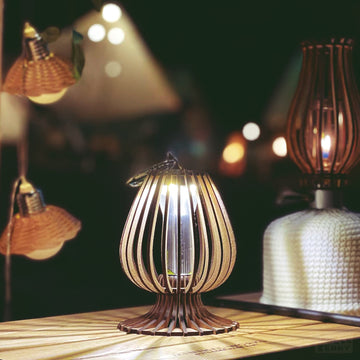 a lit candle sitting on top of a wooden table 