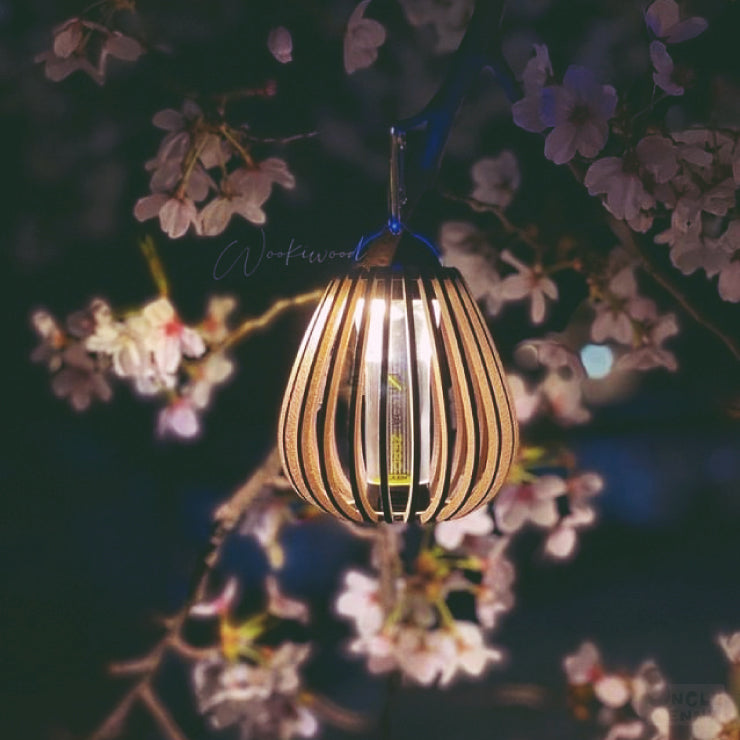 a lit candle sitting on top of a wooden table 